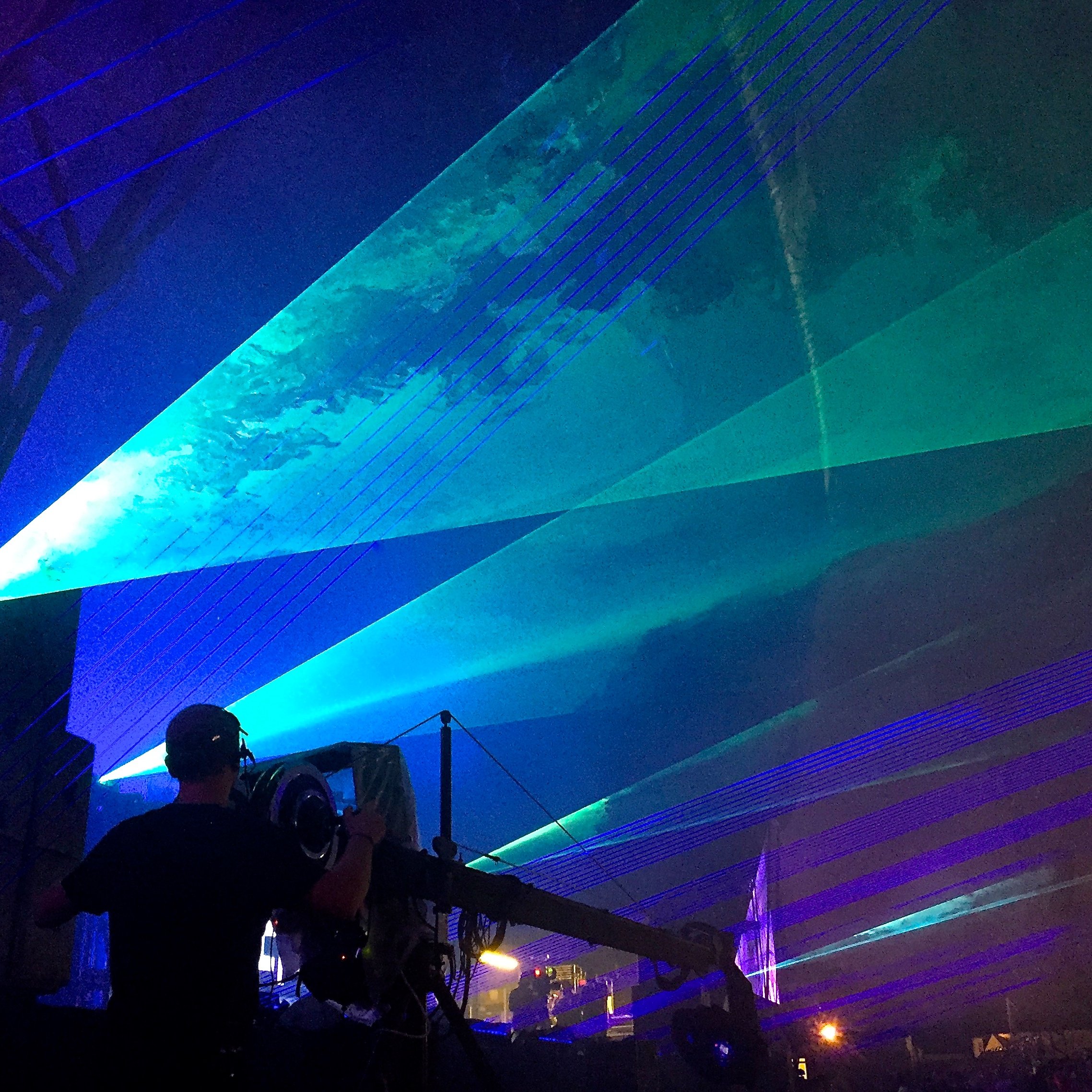 Operating the Jimmy Jib at a festival laser show, with beams over the crowd